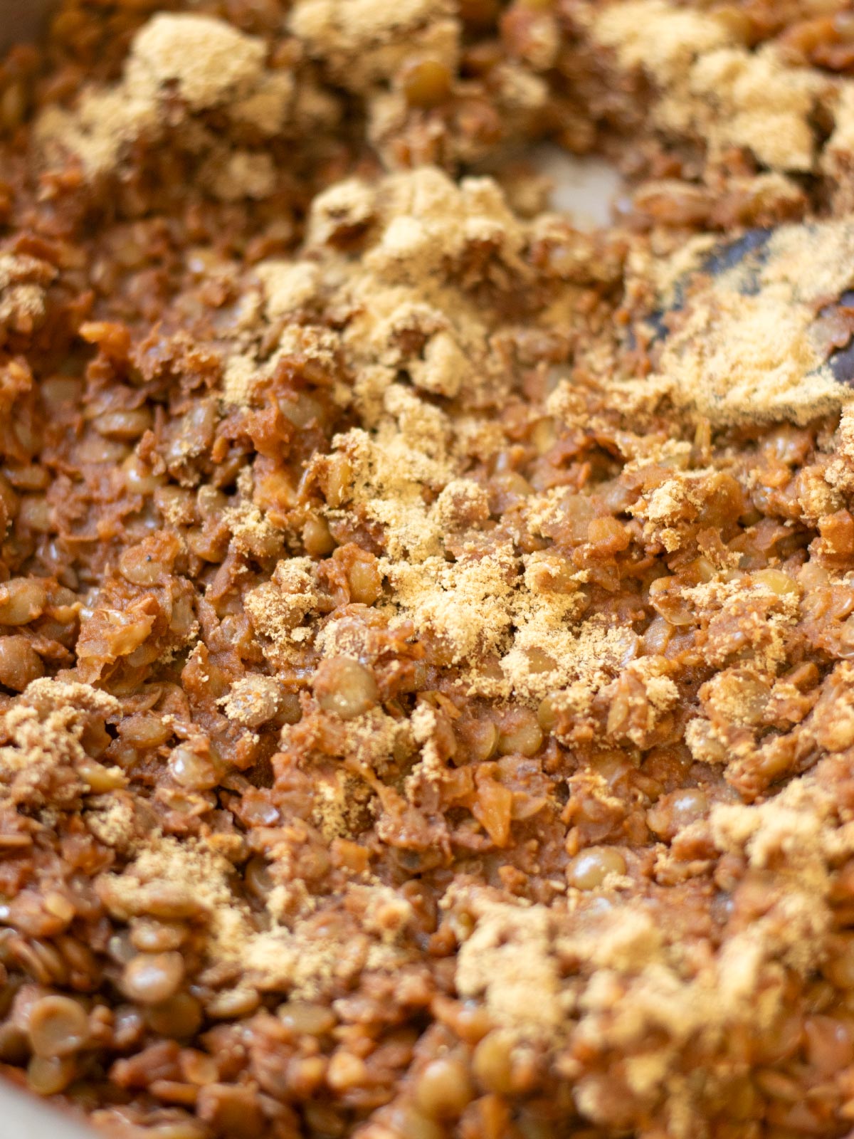 Cooking lentil taco meat with nutritional eyast and walnuts.