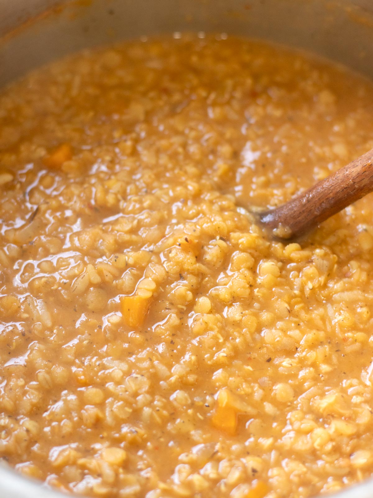 Cooking turkish lentil bulgur soup with rice.