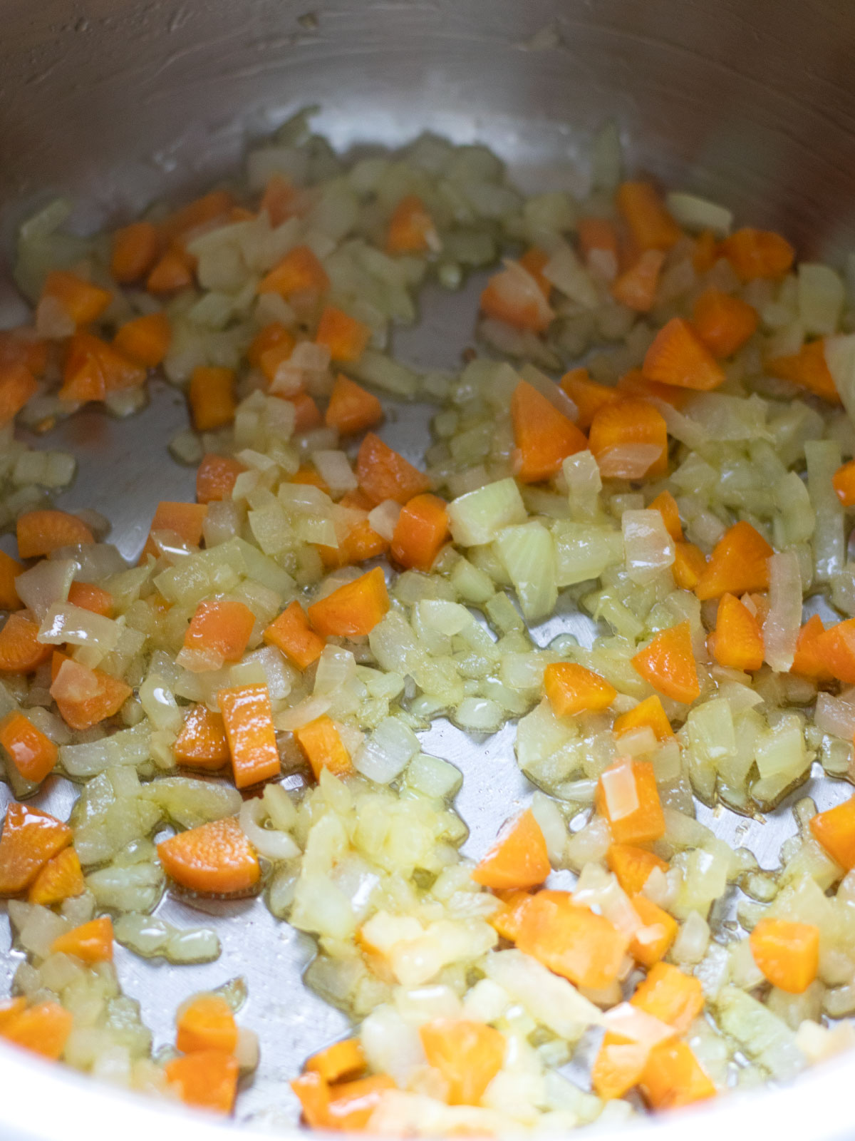 Cooking vegetables for lentil bulgur rice soup.