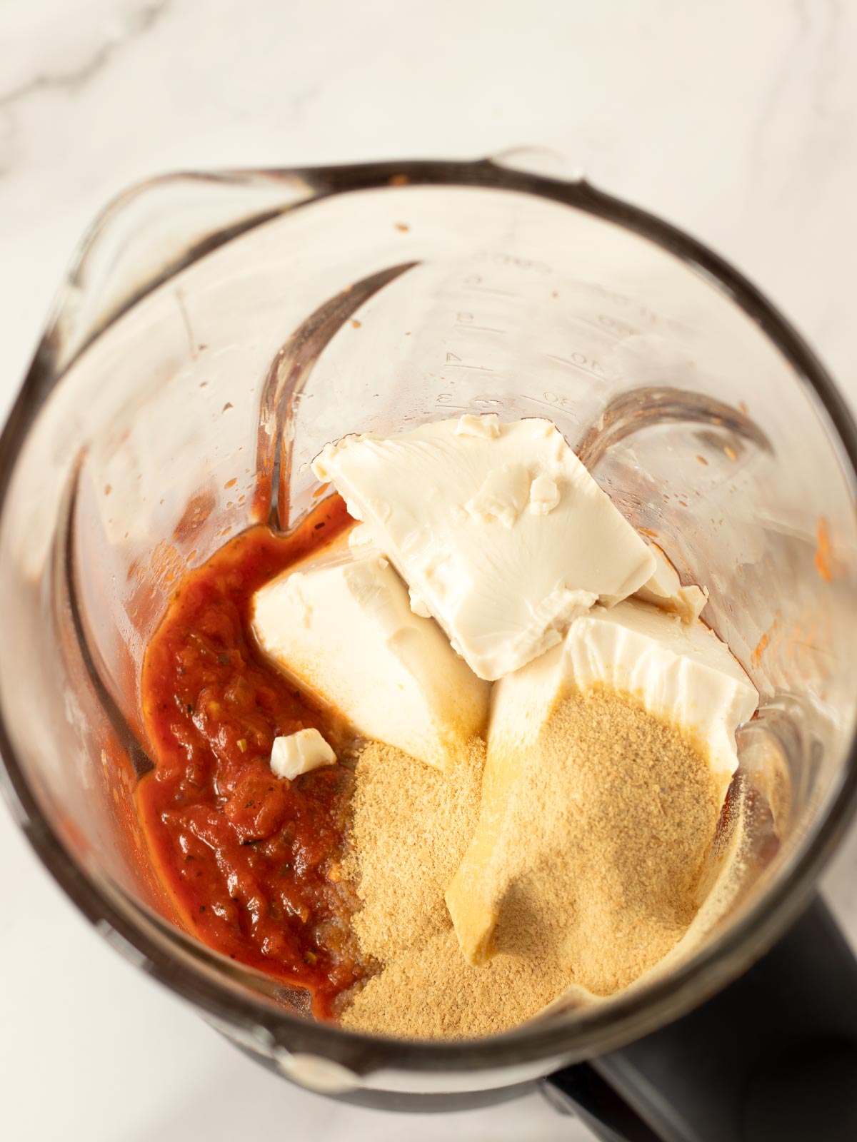 Ingredients for silken tofu tomato pasta sauce in a blender.